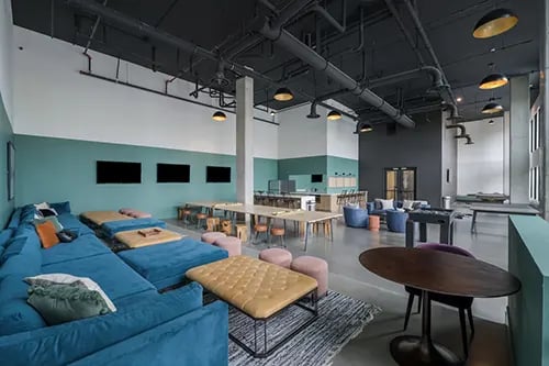 Blue sectional sofa foosball table common area at HERE Reno in Reno Student Accommodation