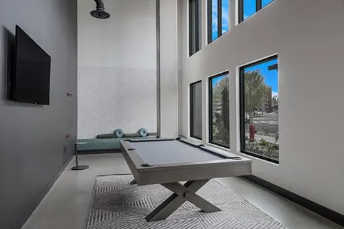 Pool table TV bench and windows common area at HERE Reno in Reno Student Accommodation