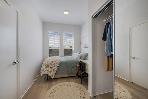 Bed desk and closet interior bedroom at HERE Reno in Reno Student Accommodation