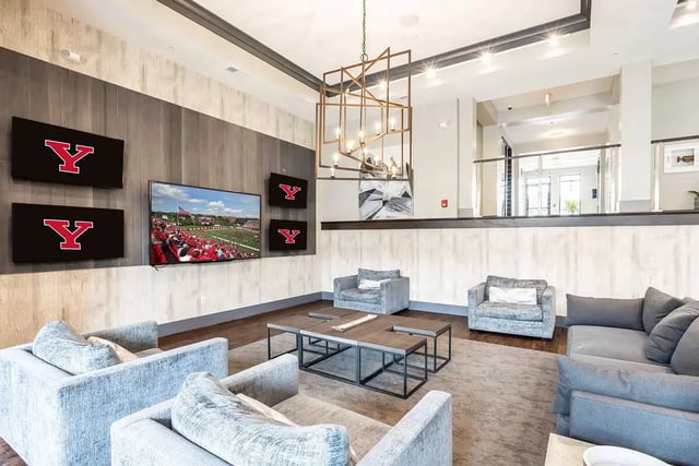 Sofas televisions and coffee tables living room at University Edge Youngstown in Youngstown Student Accommodation