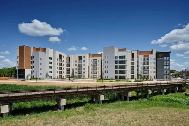 Modern apartments with balconies under blue sky exterior at The View on the Square in San Marcos Student Accommodation