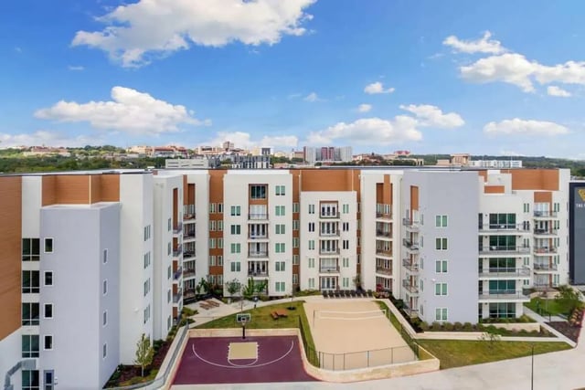 Apartment building with basketball and volleyball courts exterior at The View on the Square in San Marcos Student Accommodation