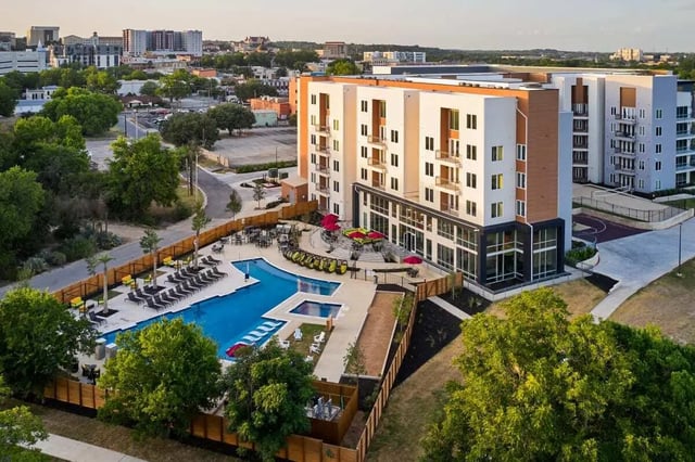 Modern apartments pool lounge chairs and outdoor seating exterior at The View on the Square in San Marcos Student Accommodation