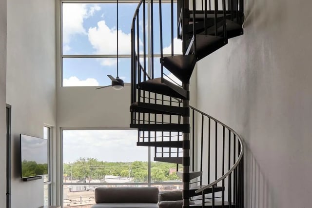 Spiral staircase television and couch living room at The View on the Square in San Marcos Student Accommodation
