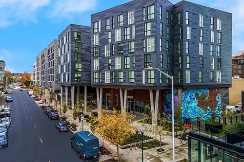Modern apartment buildings with mural street view exterior at HERE Seattle in Seattle Student Accommodation