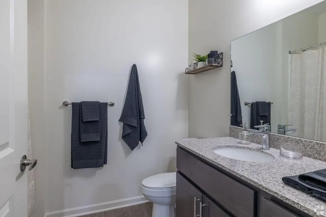 Toilet towels vanity sink and shelf bathroom at Paloma Kent in Kent Student Accommodation