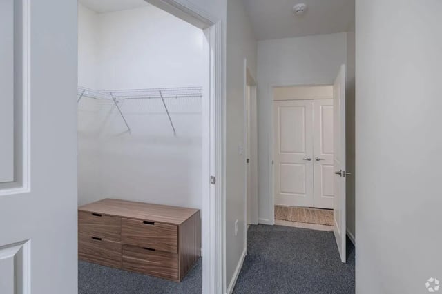 Closet with dresser and hallway with doors at Paloma Kent in Kent Student Accommodation
