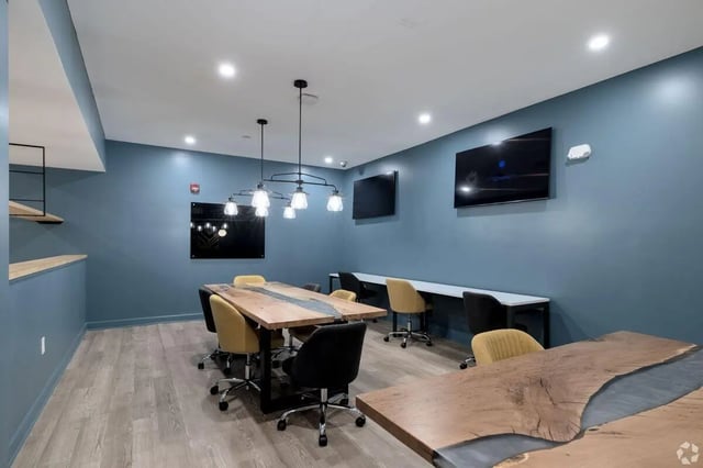 Conference room with tables chairs and televisions conference room at Paloma Kent in Kent Student Accommodation