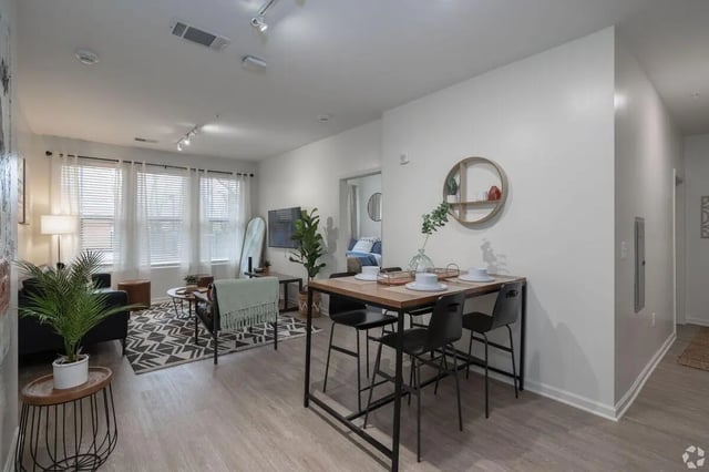 Dining table with chairs and living area living room at Paloma Kent in Kent Student Accommodation