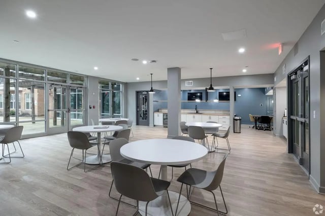 Round tables with chairs kitchen area common room at Paloma Kent in Kent Student Accommodation