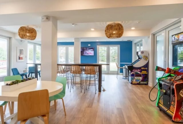 Round table arcade machines and bar seating playing area at Paloma Raleigh in Raleigh Student Accommodation