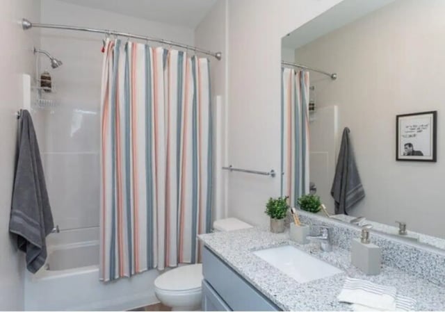 Striped shower curtain tub toilet sink mirror bathroom at Paloma Raleigh in Raleigh Student Accommodation