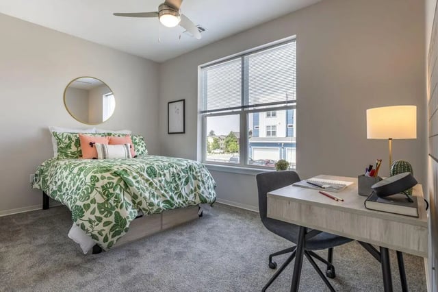 Bed with patterned duvet and desk area Bedroom at Paloma Raleigh in Raleigh Student Accommodation