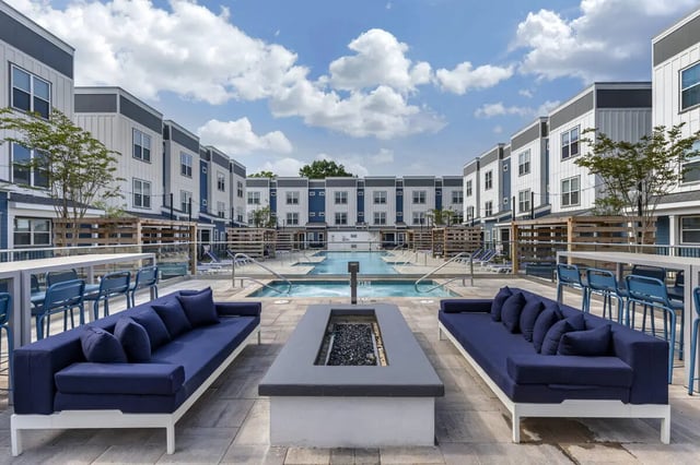 Couches fire pit pool and buildings exterior at Paloma Raleigh in Raleigh Student Accommodation