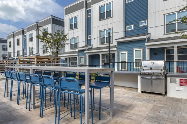 Blue bar stools at high table grill exterior at Paloma Raleigh in Raleigh Student Accommodation