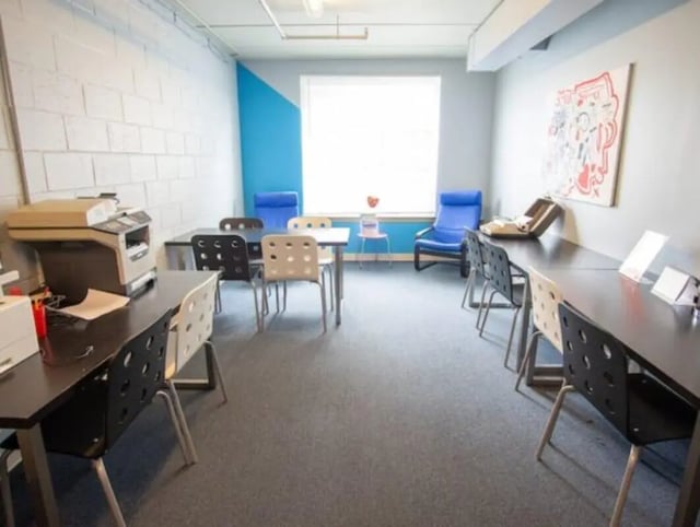 Desks chairs printer and artwork study area at HH Cresmont Apartments in Baltimore Student Accommodation