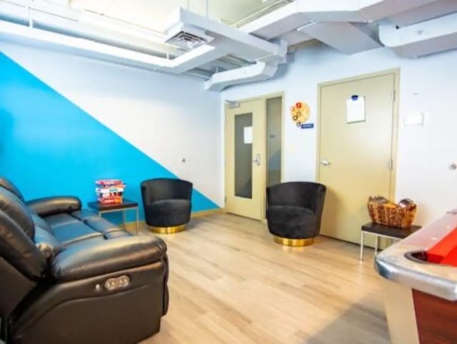 Leather couch black chairs pool table living room at HH Cresmont Apartments in Baltimore Student Accommodation