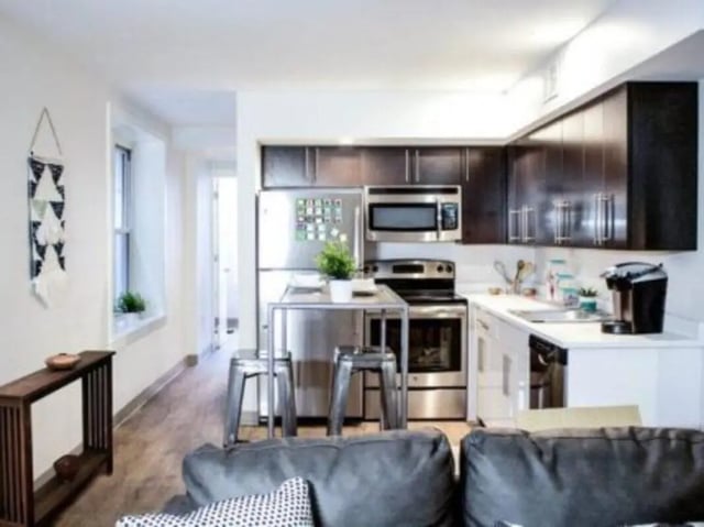 Modern kitchen with stainless steel appliances and island kitchen at The Legacy at Powelton Village in Philadelphia Student Accommodation