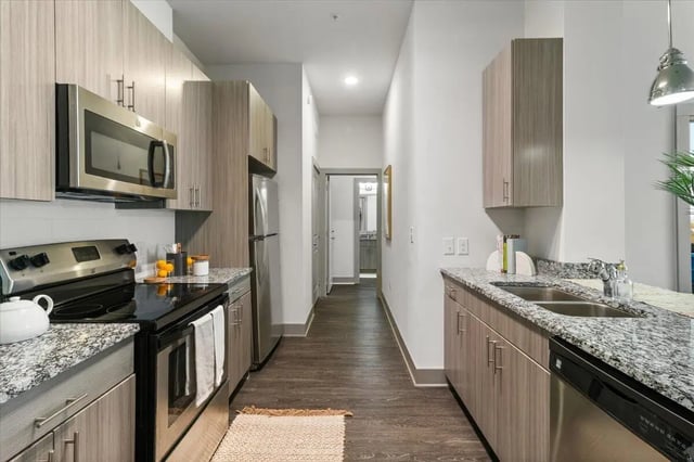 Modern kitchen with stainless steel appliances and granite countertops kitchen at Paloma West Midtown in Atlanta Student Accommodation