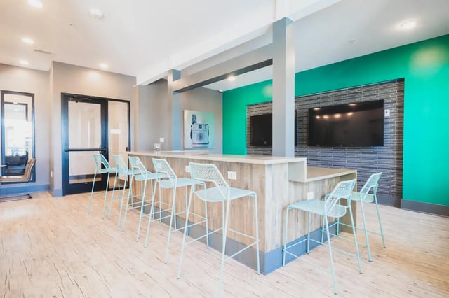 Bar stools and televisions common area at Paloma West Midtown in Atlanta Student Accommodation