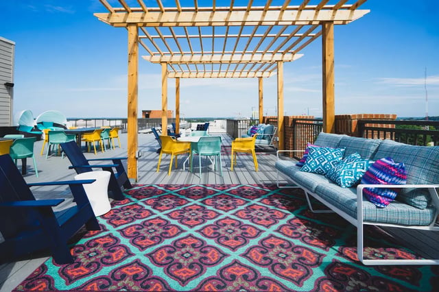 Colorful outdoor seating area with pergola and ocean view outdoor area at Paloma West Midtown in Atlanta Student Accommodation