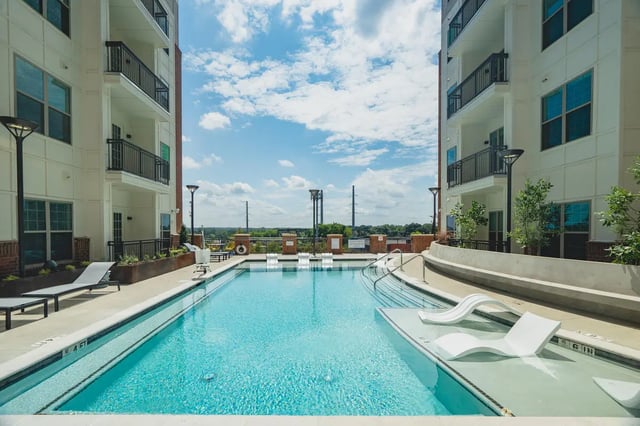 Apartment buildings with pool and lounge chairs exterior at Paloma West Midtown in Atlanta Student Accommodation