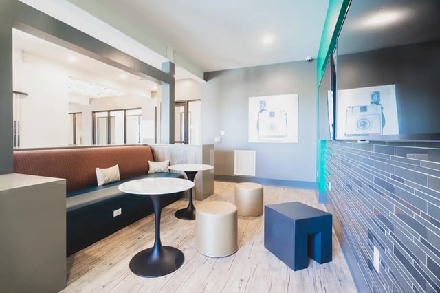 Sofa tables stools and TV lounge area at Paloma West Midtown in Atlanta Student Accommodation