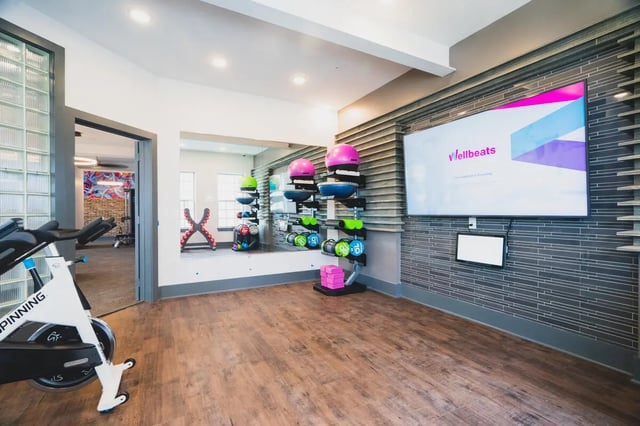 Spin bike exercise equipment and TV fitness room at Paloma West Midtown in Atlanta Student Accommodation