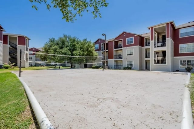Volleyball court and apartment buildings exterior at University Trails College Station in College Station Student Accommodation