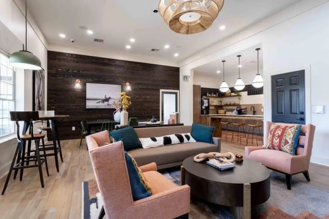 Sofa chairs coffee table kitchen and bar living room at University Trails College Station in College Station Student Accommodation