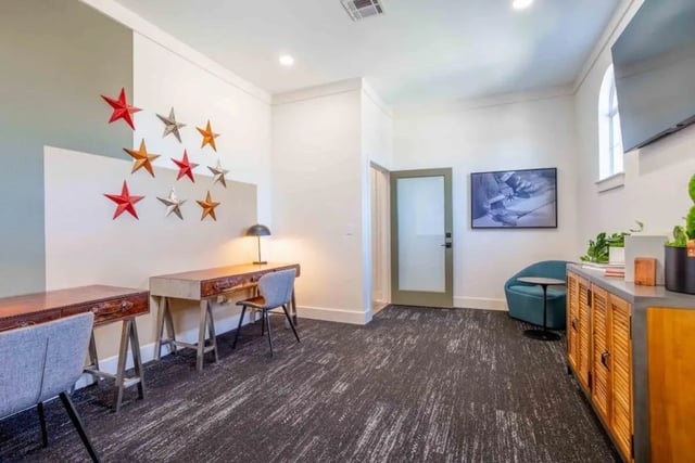 Desks chairs lamp stars and TV study area at University Trails College Station in College Station Student Accommodation