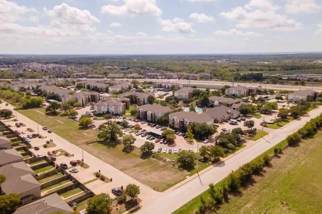 Apartment buildings with parking lots and pool exterior at University Trails College Station in College Station Student Accommodation