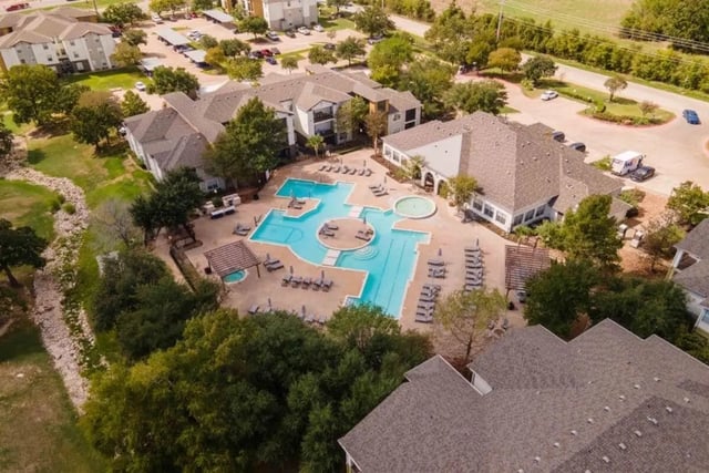 Apartment complex with swimming pool and lounge area exterior at University Trails College Station in College Station Student Accommodation
