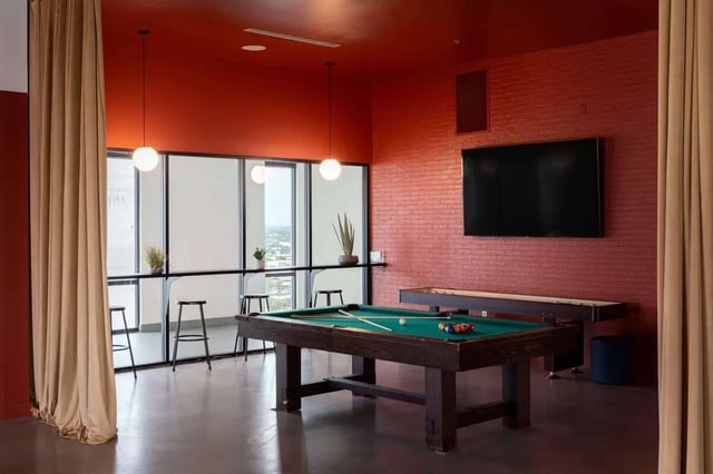 Billiard table shuffleboard bar and stools recreation area at The Carmin in Tempe Student Accommodation