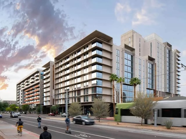 Modern apartments with balconies and streetcar exterior at The Carmin in Tempe Student Accommodation