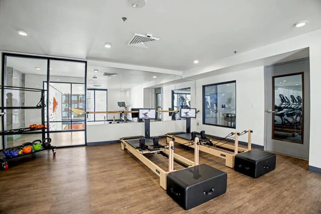 Two reformers weight rack climbing wall gym at The Carmin in Tempe Student Accommodation