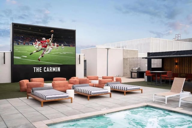 Outdoor seating hot tub and large screen exterior at The Carmin in Tempe Student Accommodation
