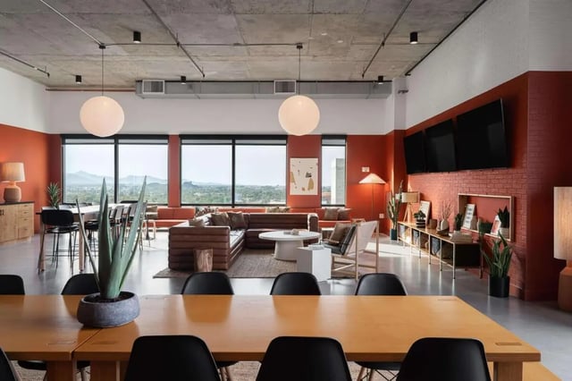 Large sectional sofa and dining tables living room at The Carmin in Tempe Student Accommodation