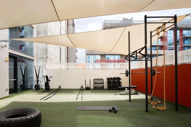 Outdoor gym equipment weights ropes and tire fitness area at The Carmin in Tempe Student Accommodation