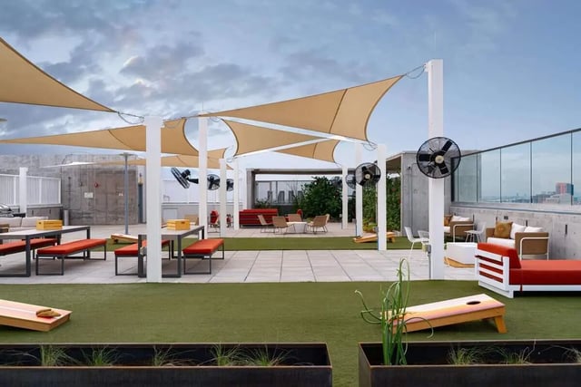 Patio furniture shade sails fans cornhole exterior at The Carmin in Tempe Student Accommodation