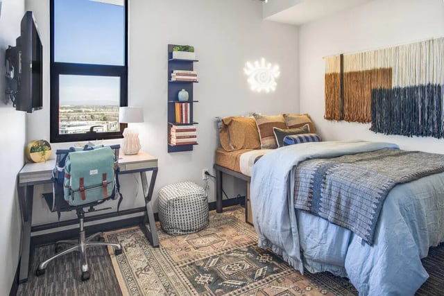 Bed desk chair backpack rug wall art bedroom at The Carmin in Tempe Student Accommodation