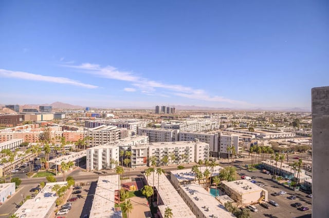 Apartment buildings with palm trees exterior at The Carmin in Tempe Student Accommodation