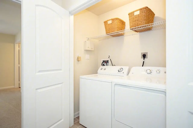 White washer dryer with storage baskets Laundry Room at Mountain Valley Apartments in Morgantown Student Accommodation