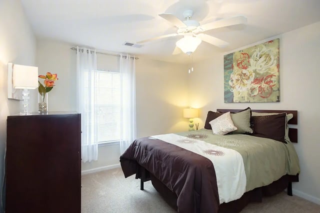 Bedroom with dresser bed and artwork bedroom at Mountain Valley Apartments in Morgantown Student Accommodation
