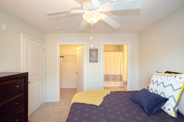 Bed dresser closet and bathroom view bedroom at Mountain Valley Apartments in Morgantown Student Accommodation