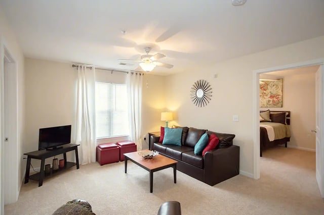 Leather sofa coffee table television living room at Mountain Valley Apartments in Morgantown Student Accommodation