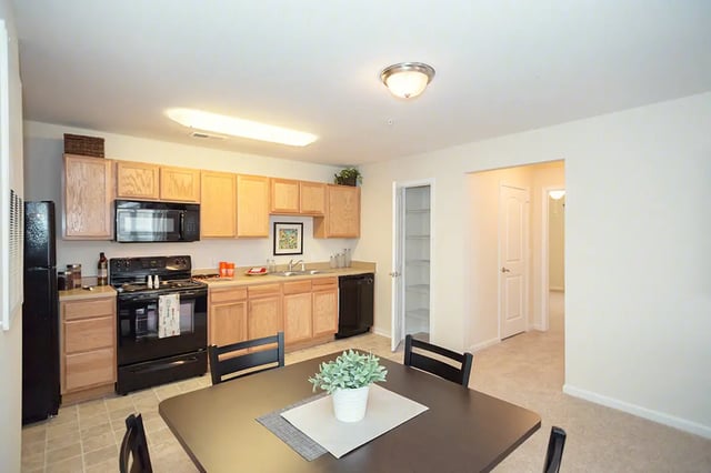 kitchen with dining table and chairs kitchen at Mountain Valley Apartments in Morgantown Student Accommodation