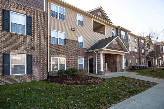 Brick and siding building with multiple windows and doors exterior at Mountain Valley Apartments in Morgantown Student Accommodation