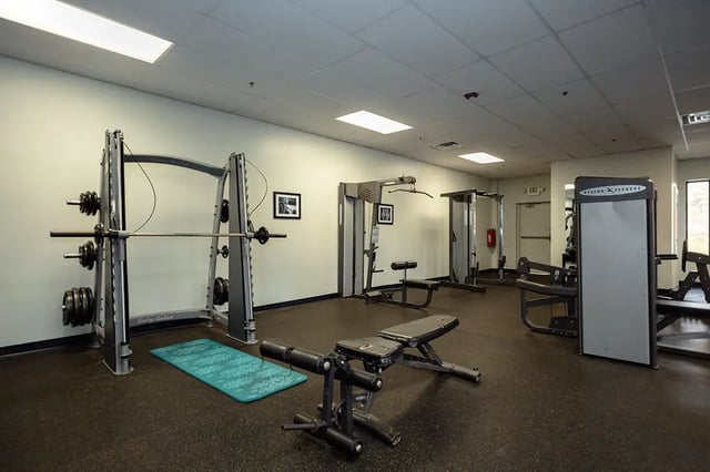 Smith machine weight rack and benches gym area at Mountain Valley Apartments in Morgantown Student Accommodation