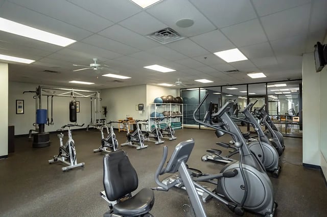Gym equipment including stationary bikes and elliptical machines playing area at Mountain Valley Apartments in Morgantown Student Accommodation